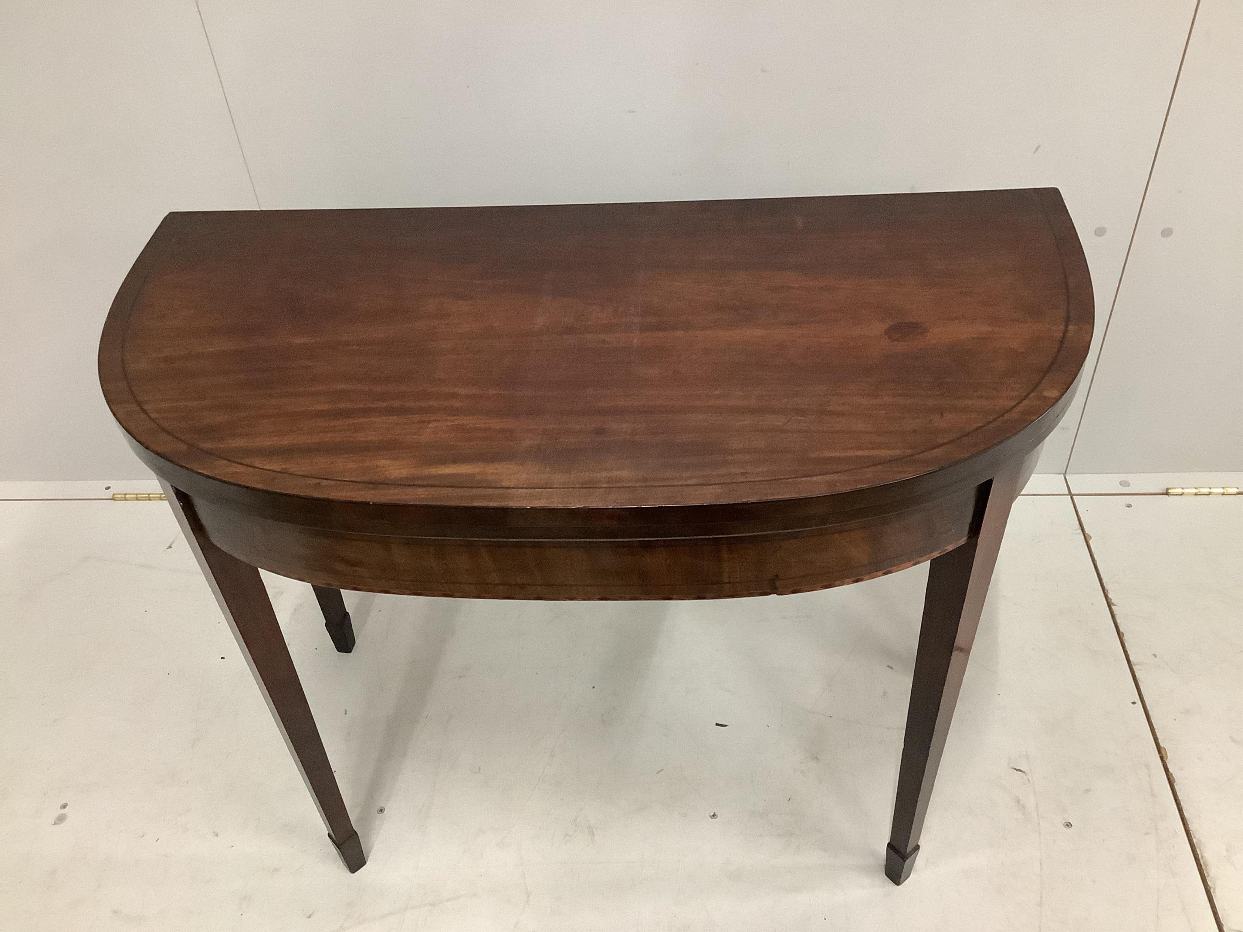 A Regency ebony strung mahogany folding tea table, width 92cm, height 74cm. Condition - fair to good